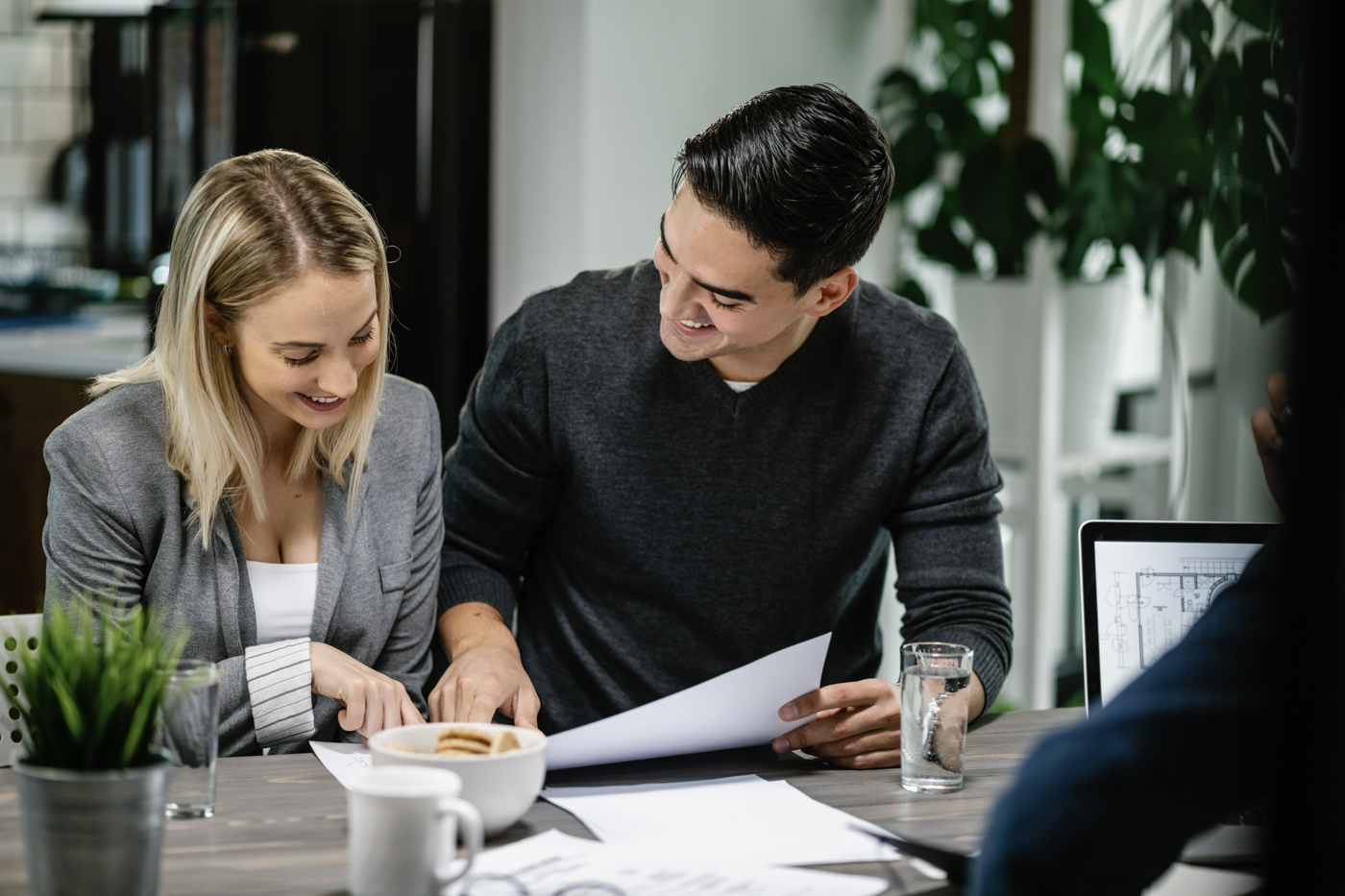 Two professionals reviewing documents at a desk during a business funding meeting
